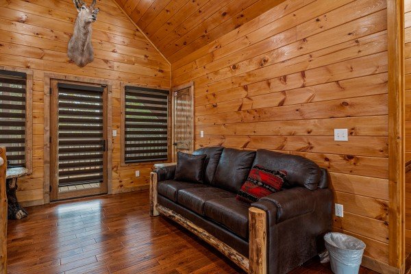 Leather couch in game room at Four Seasons Grand, a 5 bedroom cabin rental located in Pigeon Forge