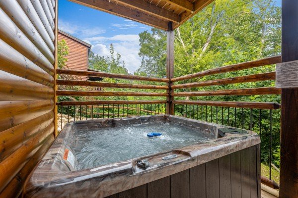 Hot tub on a deck at Pool & a View, a 2 bedroom cabin rental located in Gatlinburg