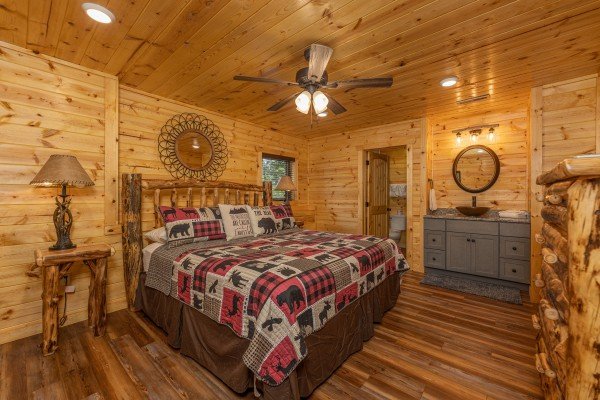 Bedroom with a king bed, night stands, lamps, and a dresser at Pool & a View, a 2 bedroom cabin rental located in Gatlinburg