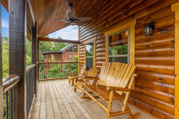 Deck with a rocking bench & chairs at Pool & a View, a 2 bedroom cabin rental located in Gatlinburg