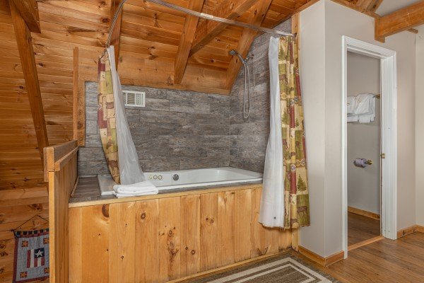Jacuzzi in the loft at Brink of Heaven, a 2 bedroom cabin rental located in Gatlinburg