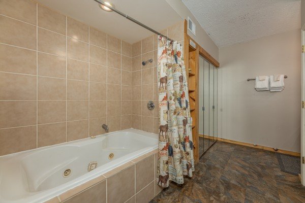 Bathroom with a jacuzzi and shower at Brink of Heaven, a 2 bedroom cabin rental located in Gatlinburg