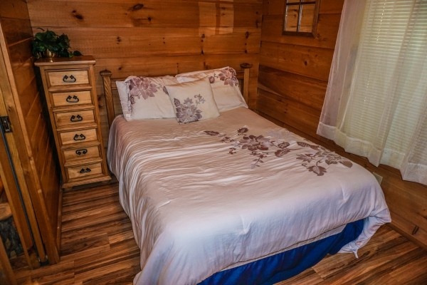 Full-sized bed in bedroom at Cozy Cabin, a 2-bedroom cabin rental located in Gatlinburg