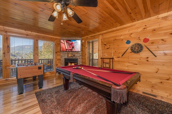 Game room with pool table, foosball, fireplace, and TV at Bears Don't Bluff, a 3 bedroom cabin rental located in Pigeon Forge