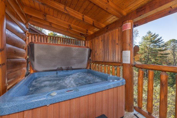 Hot tub on a covered deck at Bears Don't Bluff, a 3 bedroom cabin rental located in Pigeon Forge