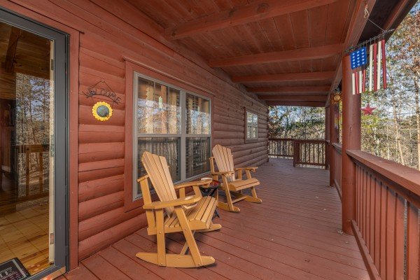 Adirondack rocking chairs on a covered deck at Wilderness Adventure, a 2 bedroom cabin rental in Pigeon Forge