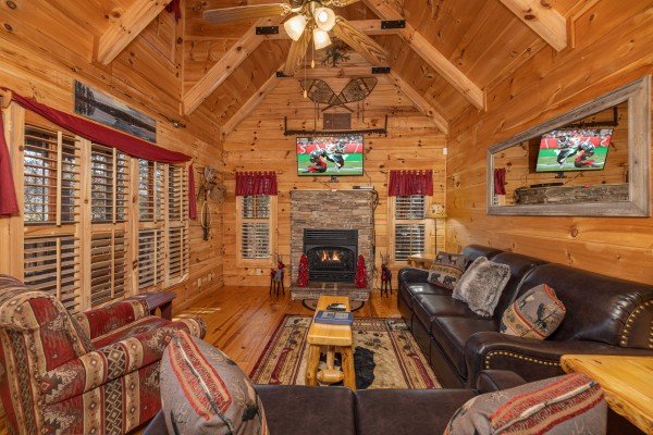 Living room fireplace and TV at Wilderness Adventure, a 2 bedroom cabin rental in Pigeon Forge
