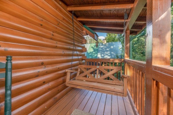 Swing on a porch at Southern Charm, a 2 bedroom cabin rental located in Pigeon Forge
