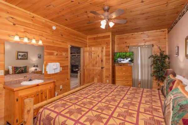 Bedroom with a sink, vanity, dresser, and television at Bearly in the Mountains, a 5-bedroom cabin rental located in Pigeon Forge