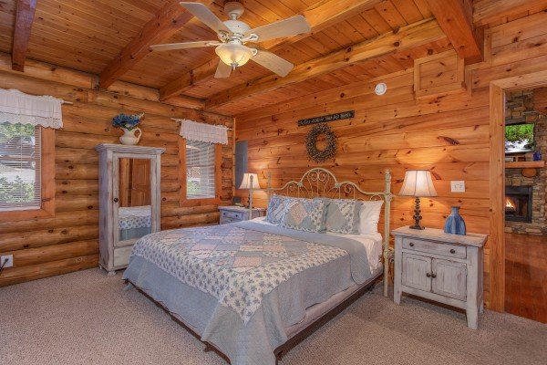 king sized bed and armoire at alpine something blue a 1 bedroom cabin rental located in pigeon forge