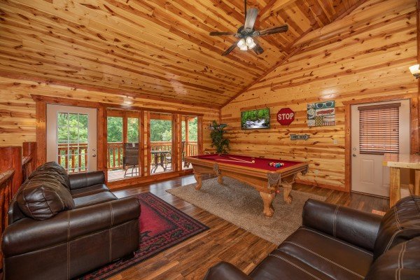 Game room with pool table and TV at The Pool Palace, a 5 bedroom cabin rental located in Pigeon Forge