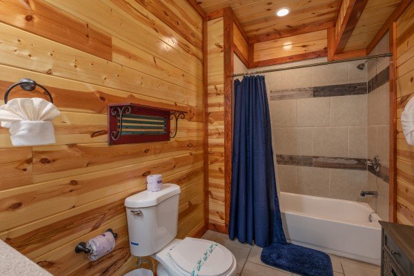 Bathroom with a tub and shower at The Pool Palace, a 5 bedroom cabin rental located in Pigeon Forge