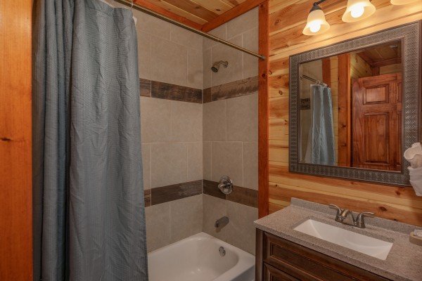 Bathroom with tub and shower at The Pool Palace, a 5 bedroom cabin rental located in Pigeon Forge