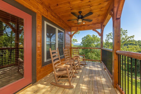Rocking chairs on the covered deck at Smoky Mountain Chalet, a 3 bedroom cabin rental located in Pigeon Forge
