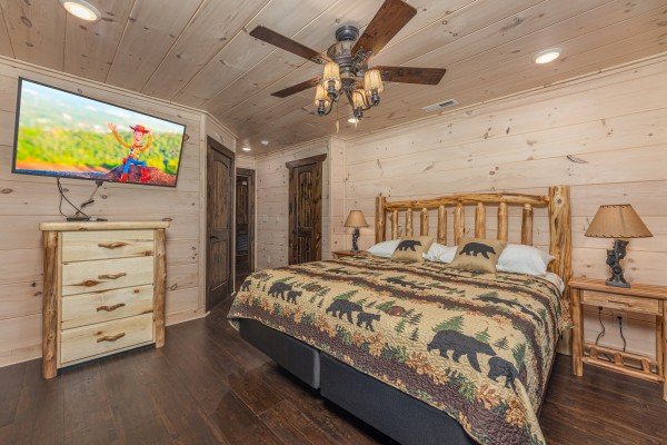 King bed, night stands, dresser, and TV in a bedroom at Smoky Mountain Chalet, a 3 bedroom cabin rental located in Pigeon Forge