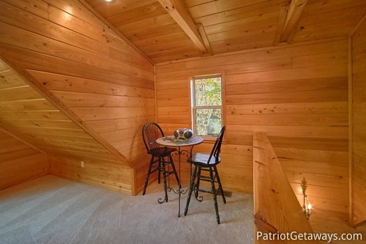 Bistro table in lofted game room at Quality Time, a 1 bedroom cabin rental located in Gatlinburg