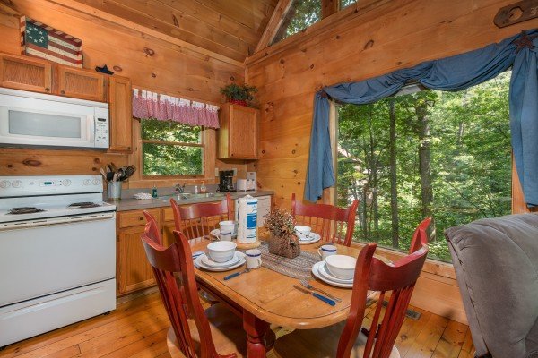 Dining table for four at Denim Blues, a 1-bedroom cabin rental located in Gatlinburg