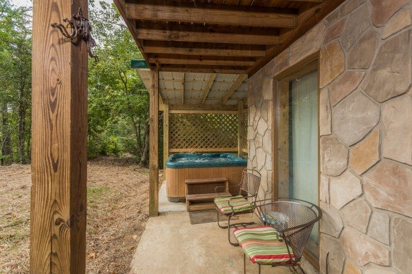 Patio with chairs and hot tub at Bird's Eye View, a 2-bedroom cabin rental located in Gatlinburg