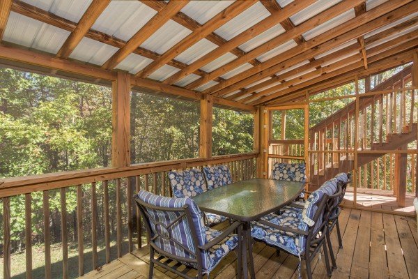 Dining table for six on the screened porch at Living on Love, a 2 bedroom cabin rental located in Pigeon Forge