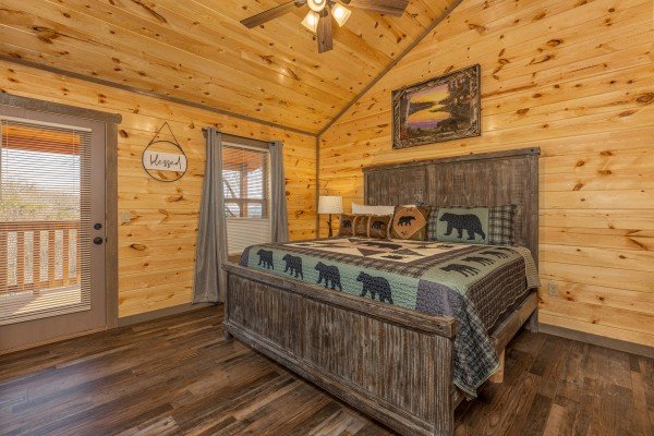 Bedroom with a king bed and deck access at Everly's Splash, a 4 bedroom cabin rental located in Pigeon Forge