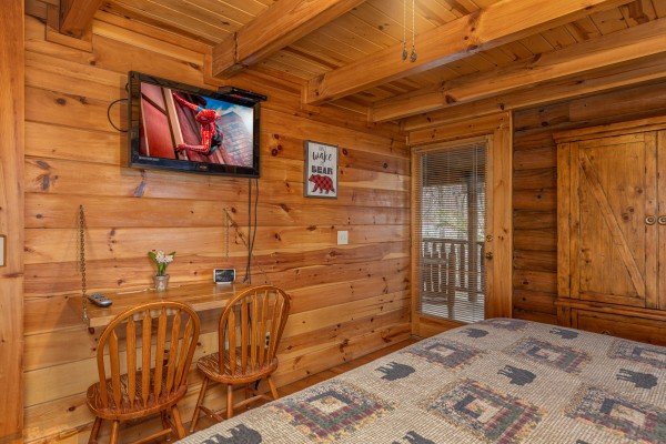 Writing desk and TV in a bedroom at A Lover's Secret, a 1 bedroom cabin rental located in Gatlinburg