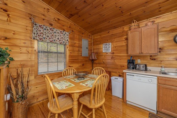 Kitchen with dining table for four at A Moment in Time, a 2 bedroom cabin rental located in Pigeon Forge