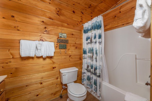 Bathroom with a tub and shower at A Moment in Time, a 2 bedroom cabin rental located in Pigeon Forge