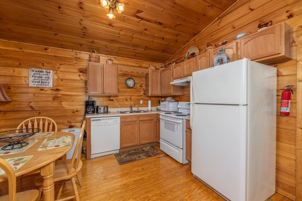 Kitchen with white appliances at A Moment in Time, a 2 bedroom cabin rental located in Pigeon Forge