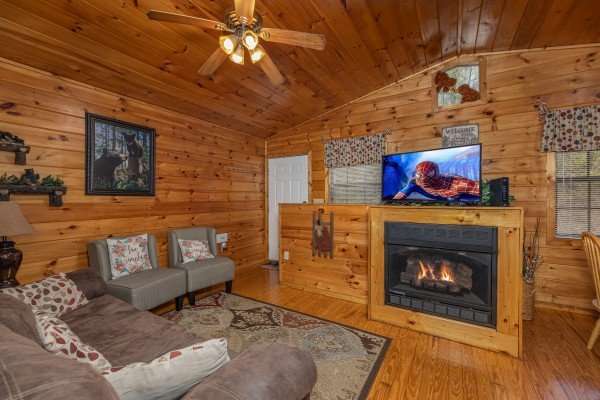 Fireplace and TV in a living room at A Moment in Time, a 2 bedroom cabin rental located in Pigeon Forge