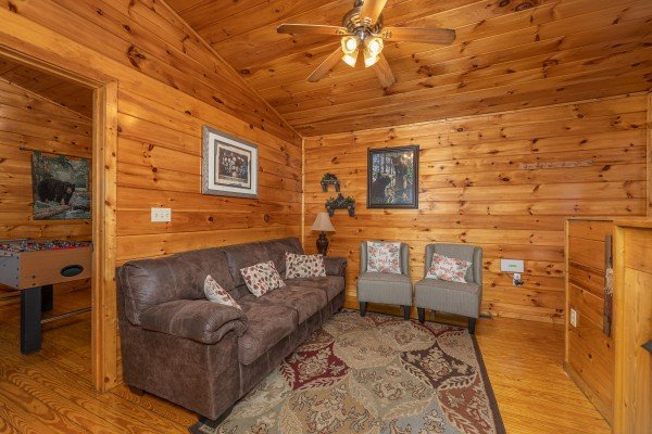 Living room with sofa and two chairs at A Moment in Time, a 2 bedroom cabin rental located in Pigeon Forge