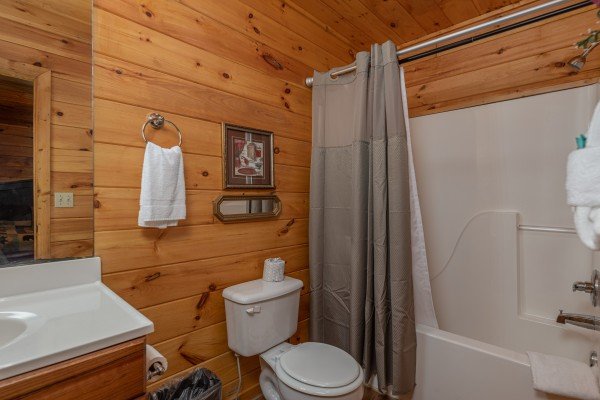 Bathroom with a tub and shower at A Moment in Time, a 2 bedroom cabin rental located in Pigeon Forge