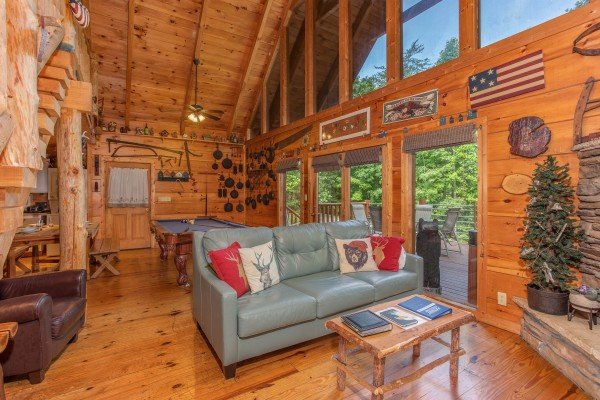 Living room with sofa and chair at Aw Paw's Place, a 1-bedroom cabin rental located in Pigeon Forge