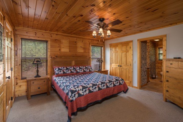 Bedroom with a king bed, night stands, and lamps at Endless View, a 4 bedroom cabin rental located in Pigeon Forge