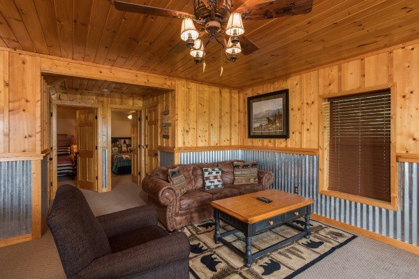 Sofa and chair in the lower living room at Endless View, a 4 bedroom cabin rental located in Pigeon Forge