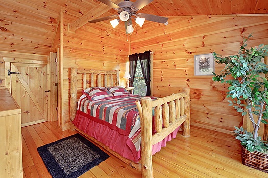 Queen-sized bed in lofted bedroom at Bearly Makin' It, a 1-bedroom cabin rental located in Gatlinburg
