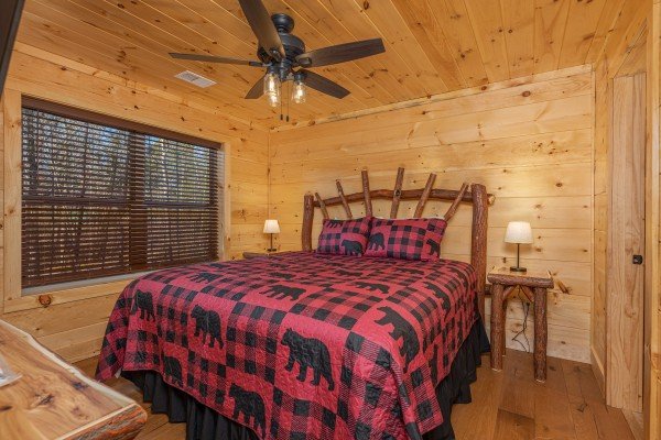 Bedroom with a bed, two night stands, and lamps at Bessy Bears Cabin, a 2 bedroom cabin rental located inGatlinburg