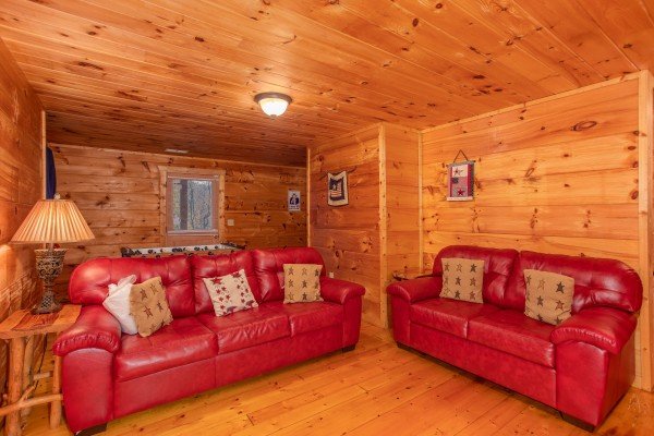 Sofa and loveseat in the lower living room at Patriot Inn, a 1 bedroom Gatlinburg cabin rental
