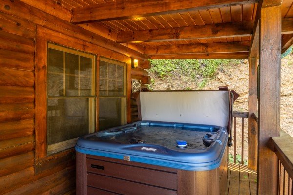 Hot tub on a covered deck at Lakeview Point, a 2 bedroom cabin rental located in Douglas Lake