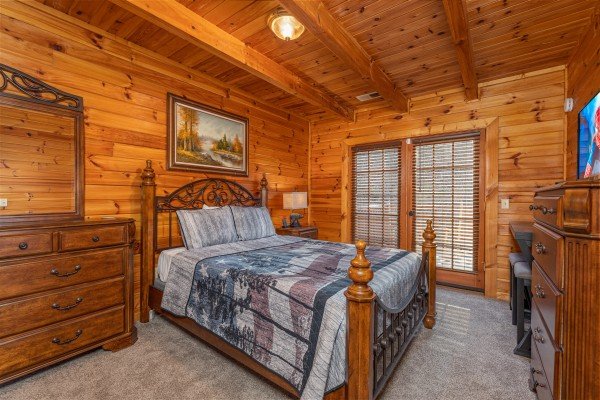 Bedroom with dressers, TV, and deck access at Lakeview Point, a 2 bedroom cabin rental located in Douglas Lake