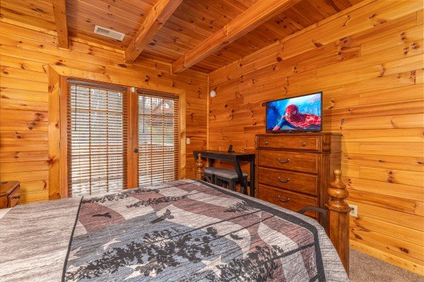 Dresser, TV, and deck access in a bedroom at Lakeview Point, a 2 bedroom cabin rental located in Douglas Lake