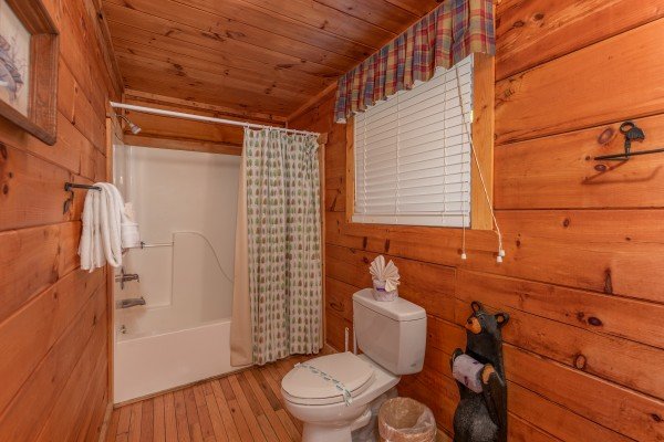 Bathroom with a tub and shower at American Beauty, a 2 bedroom cabin rental located in Pigeon Forge