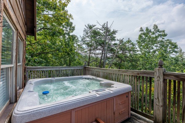 Hot tub on the porch at American Beauty, a 2 bedroom cabin rental located in Pigeon Forge