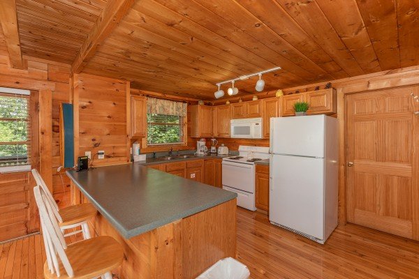 Kitchen with white appliances at American Beauty, a 2 bedroom cabin rental located in Pigeon Forge
