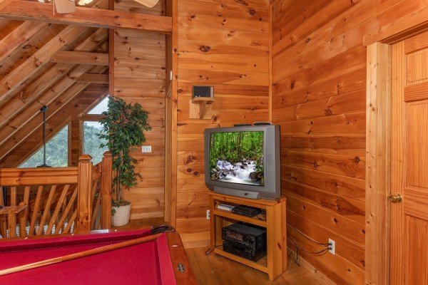 TV in the game room at American Beauty, a 2 bedroom cabin rental located in Pigeon Forge