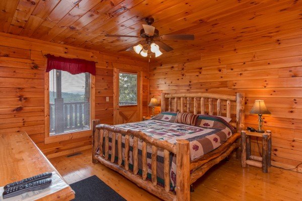 Bedroom with a log bed, night stands, and lamps at A Beautiful Memory, a 4 bedroom cabin rental located in Pigeon Forge