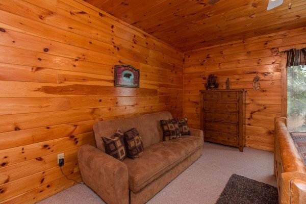 Sofa in the game room at A Beautiful Memory, a 4 bedroom cabin rental located in Pigeon Forge