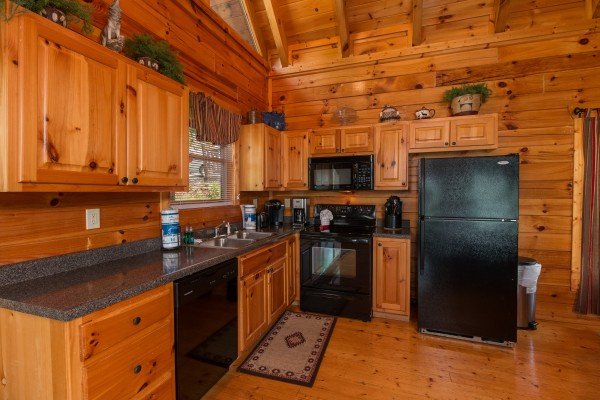 Kitchen with black appliances at A Beautiful Memory, a 4 bedroom cabin rental located in Pigeon Forge