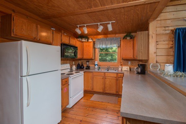 Kitchen with white appliances at My Blue Heaven, a 1 bedroom cabin rental located in Gatlinburg