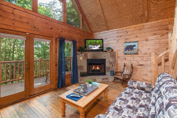 Living room with fireplace and TV at My Blue Heaven, a 1 bedroom cabin rental located in Gatlinburg