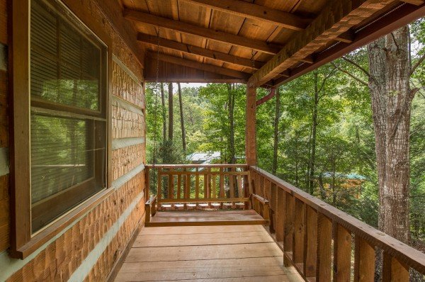 Porch swing on a covered deck at Little Bear, a 1 bedroom cabin rental located in Pigeon Forge